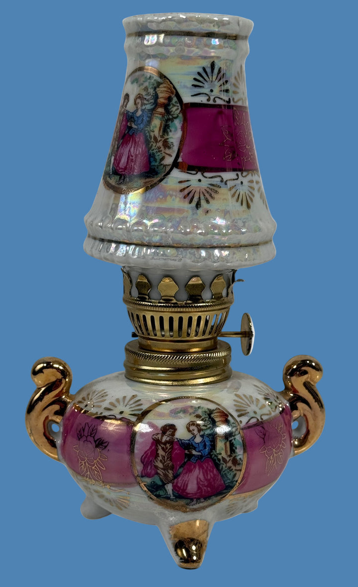 Decorative oil lamp with artistic designs on a white background
