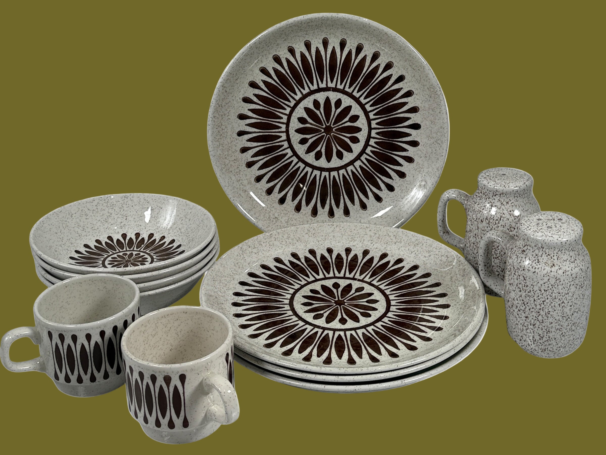 Ceramic dinnerware set with decorative black patterns on a white background