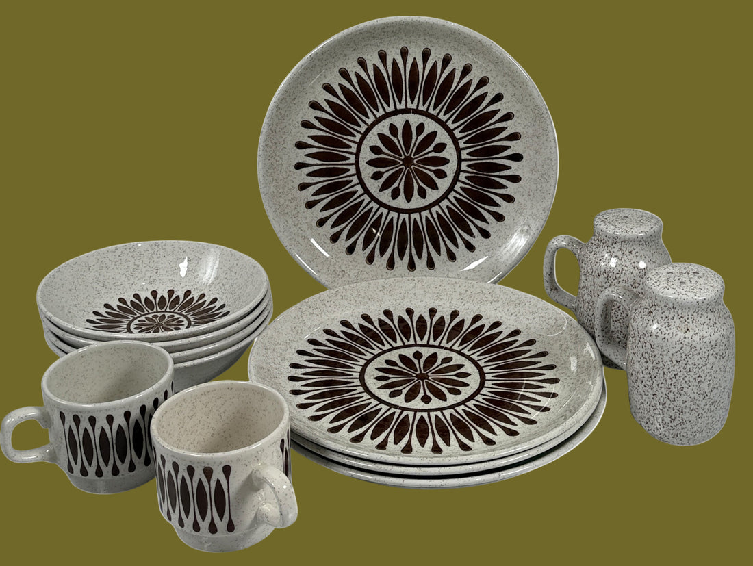Ceramic dinnerware set with decorative black patterns on a white background