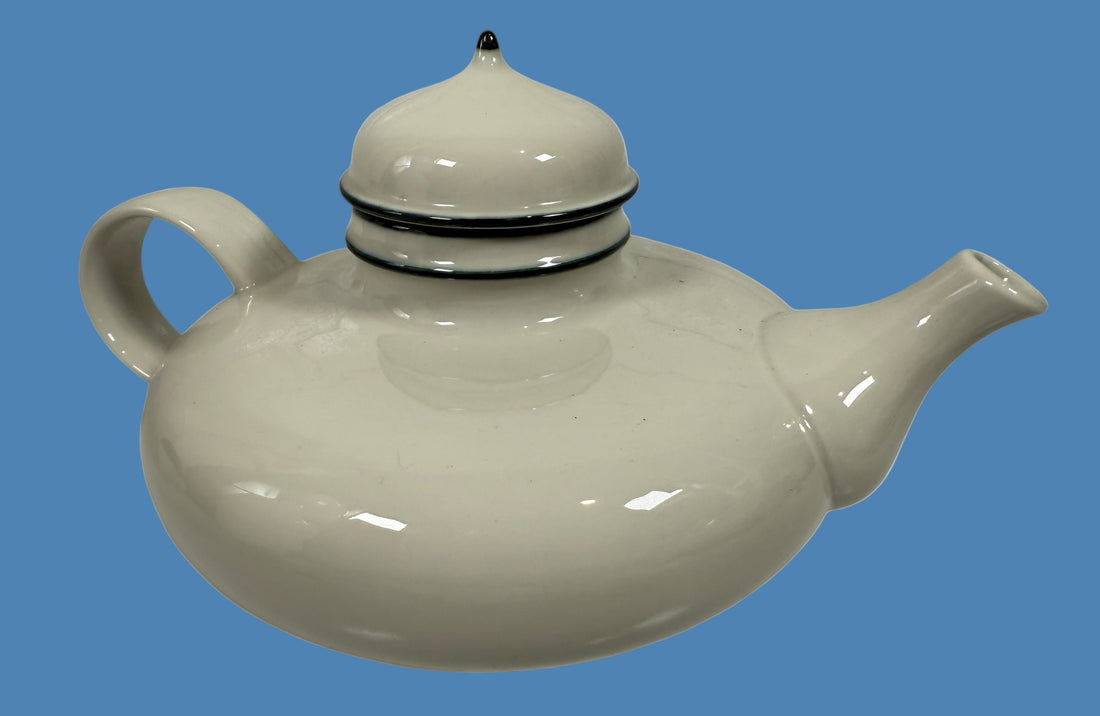 White ceramic teapot with a lid on a white background