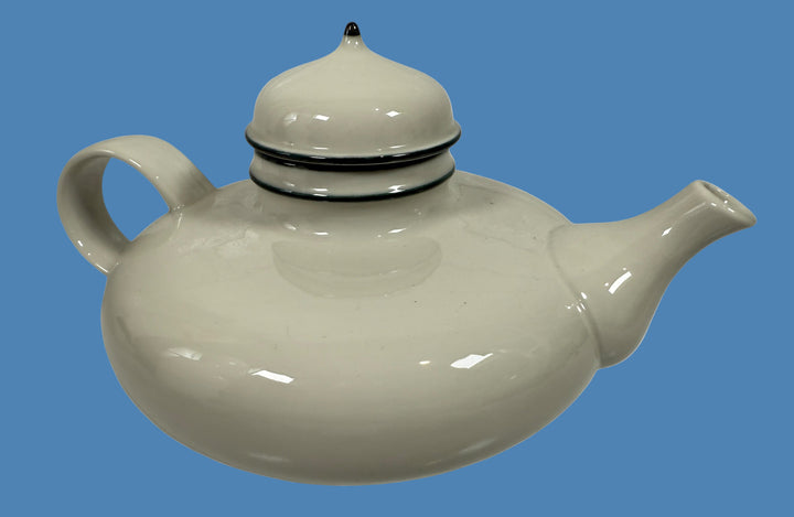 White ceramic teapot with a lid on a white background