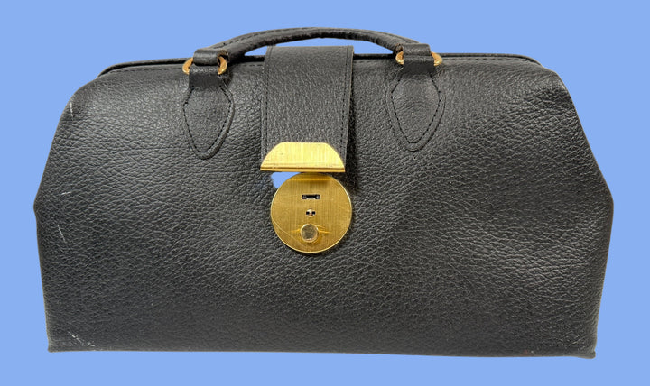 Black leather bag with a gold lock on a white background