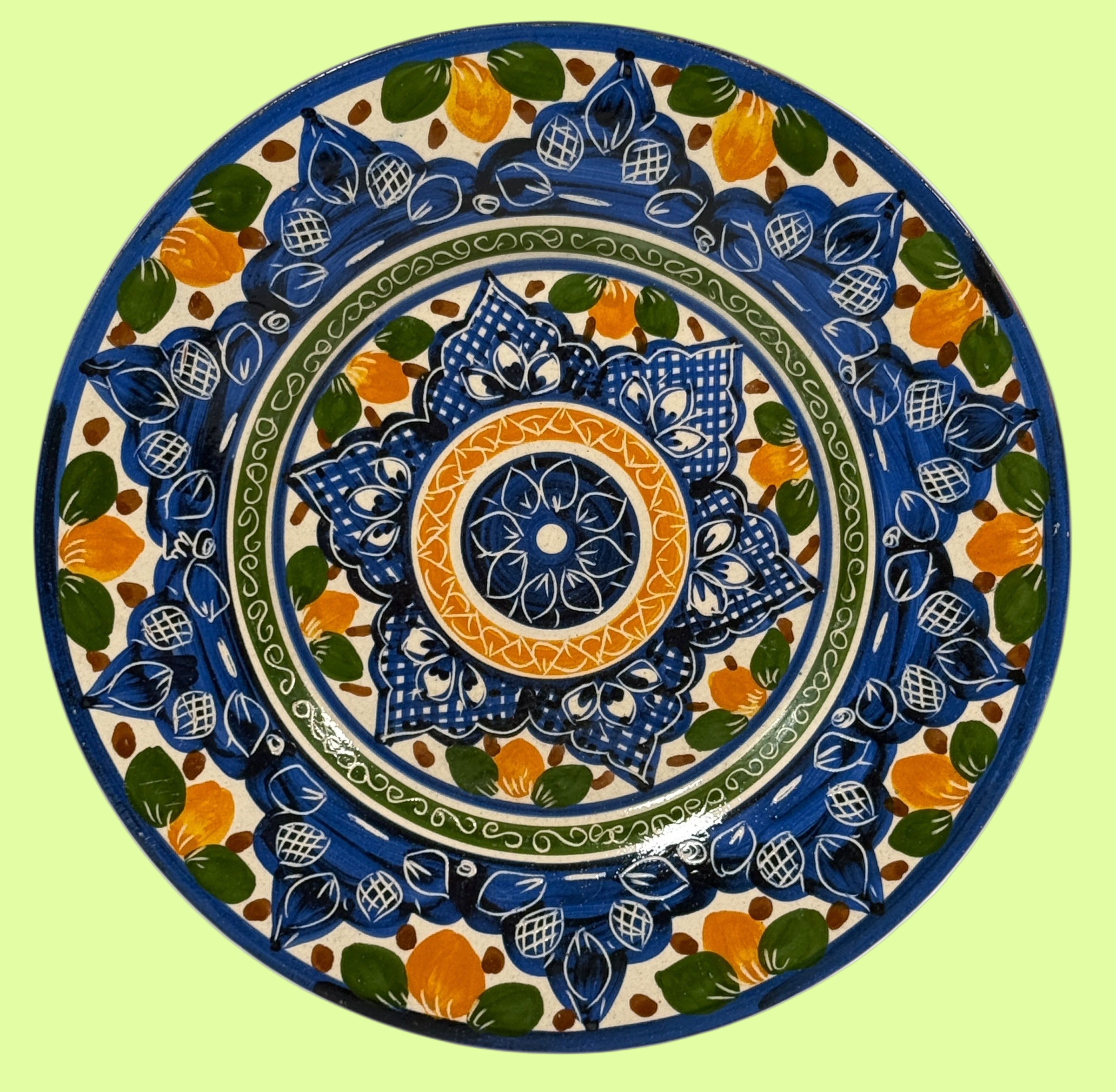 Decorative plate with blue, green, and orange patterns on a white background