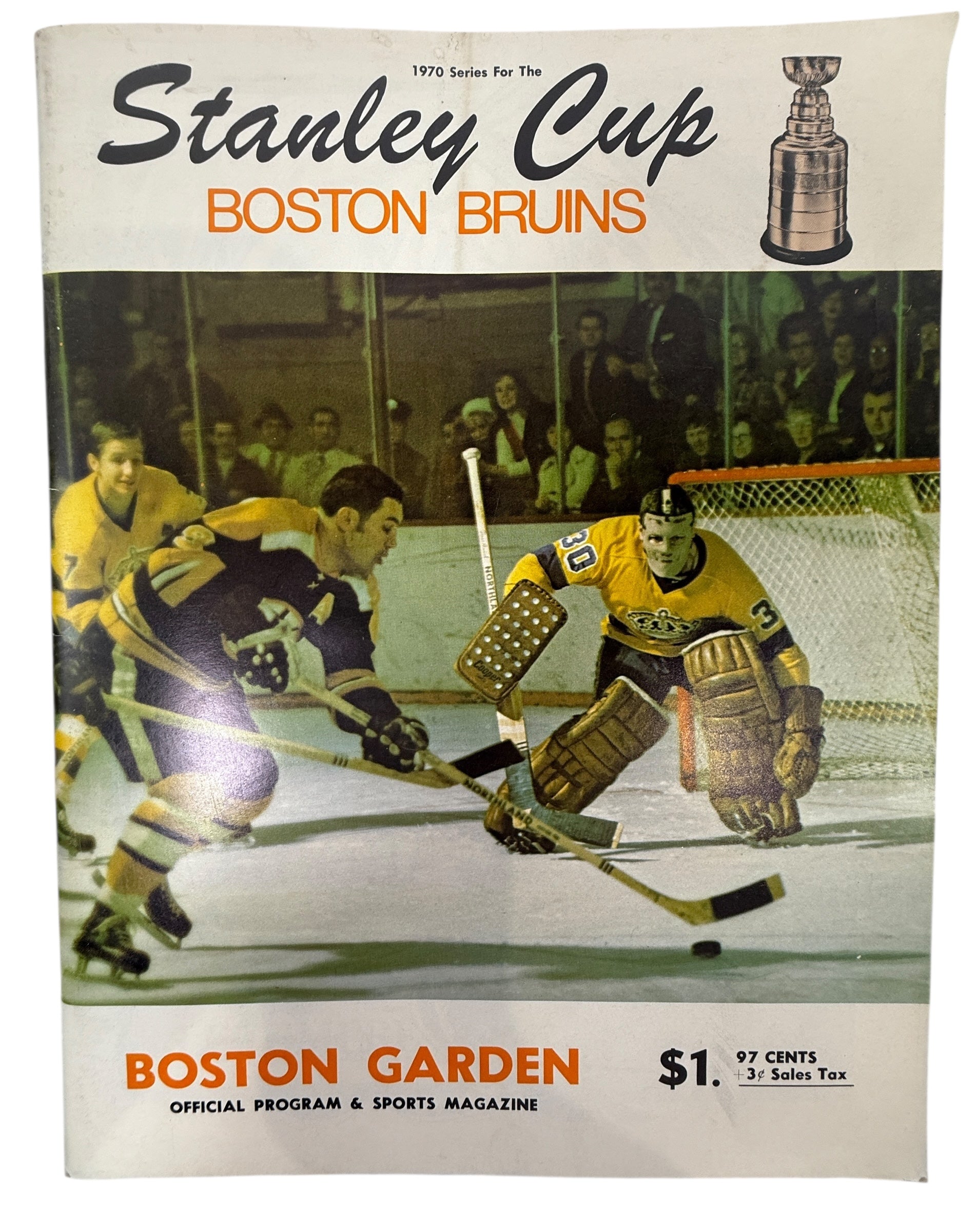 Vintage hockey program cover featuring Boston Bruins players and Stanley Cup logo.