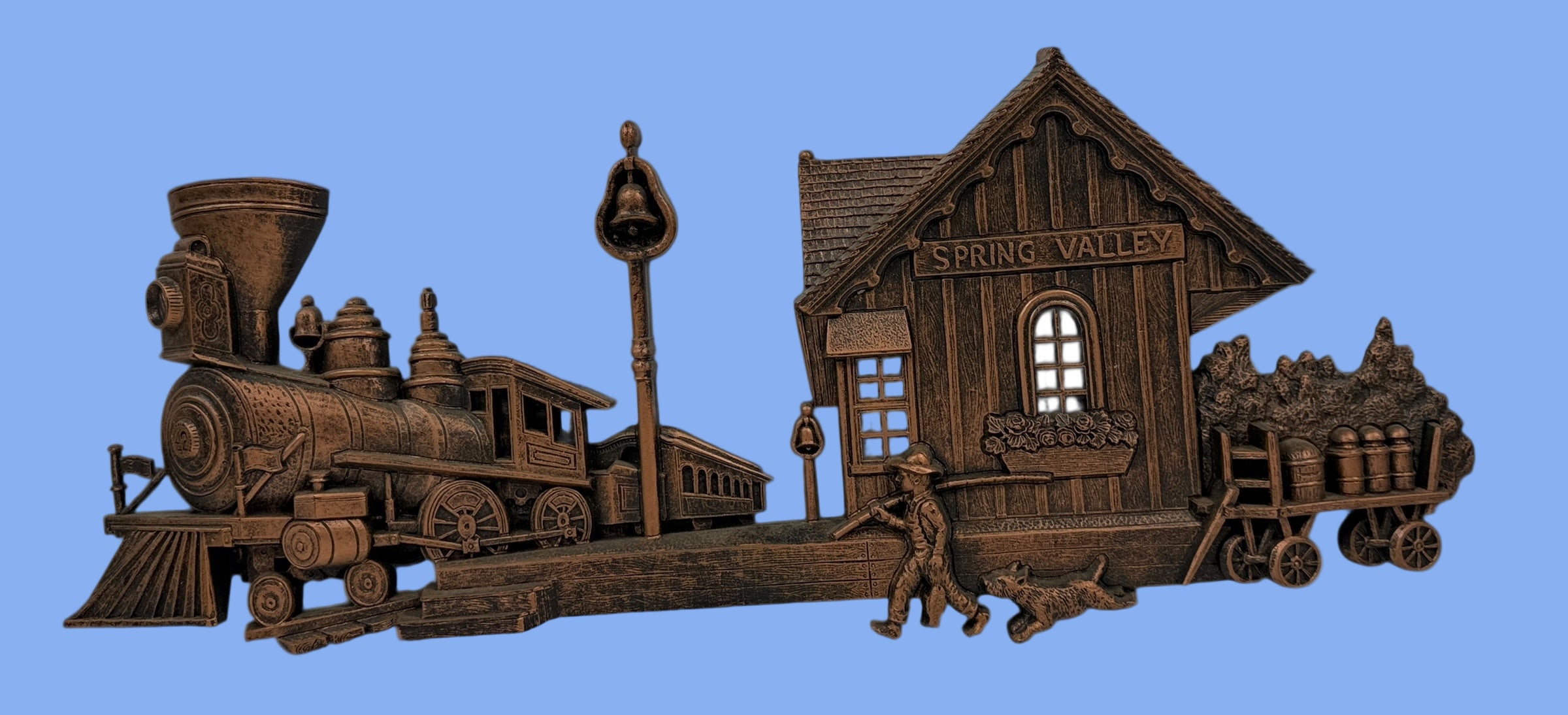 Wooden model of a steam locomotive and station with 'Spring Valley' on a white background