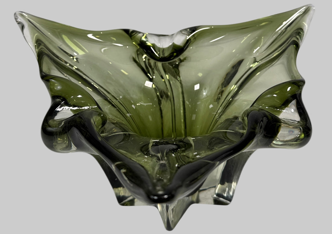 Chalet Green glass bowl with a unique, organic shape on a white background