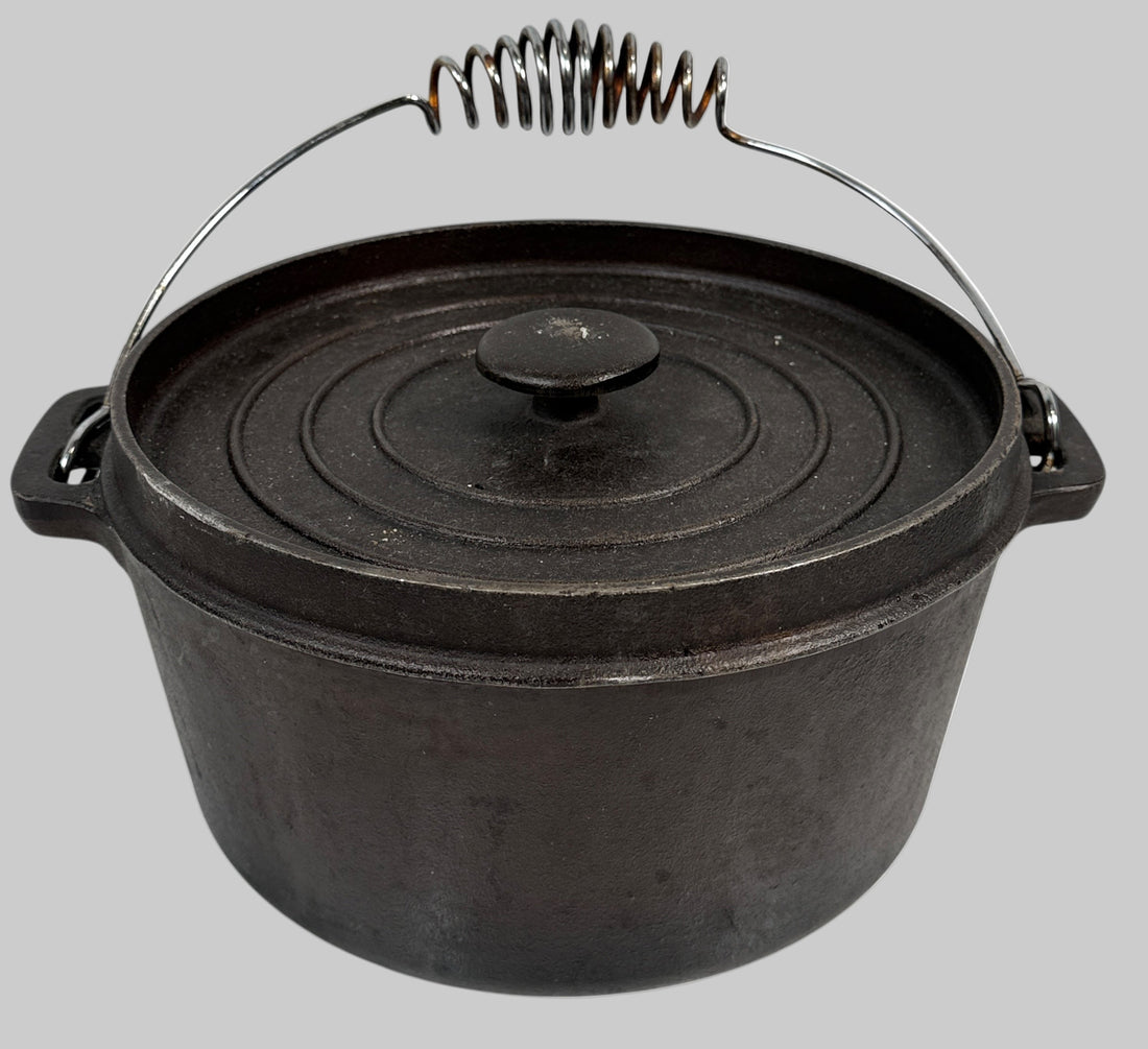 Black cast iron pot with lid on a white background