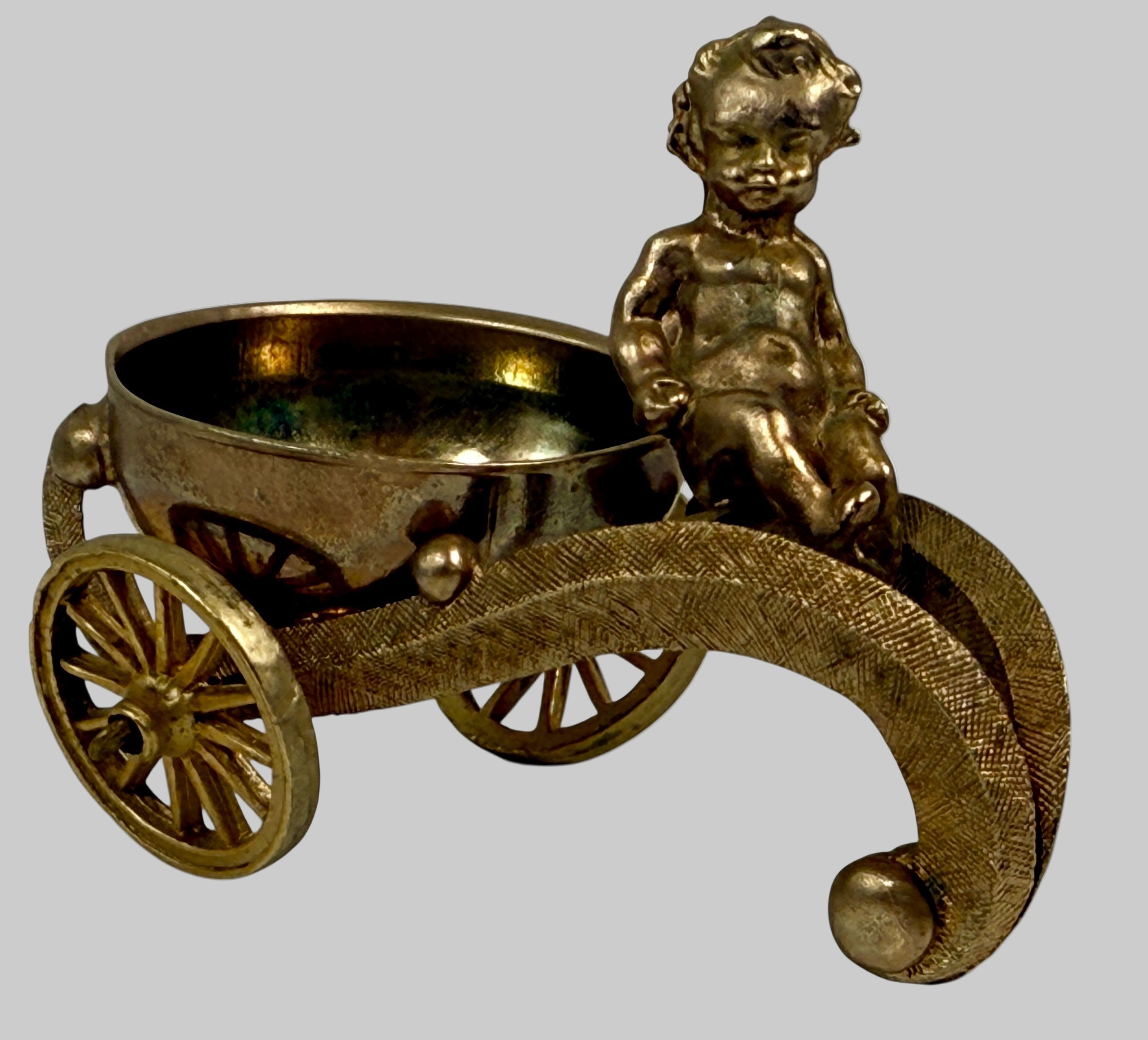Bronze cherub in a cart with a bowl on a white background