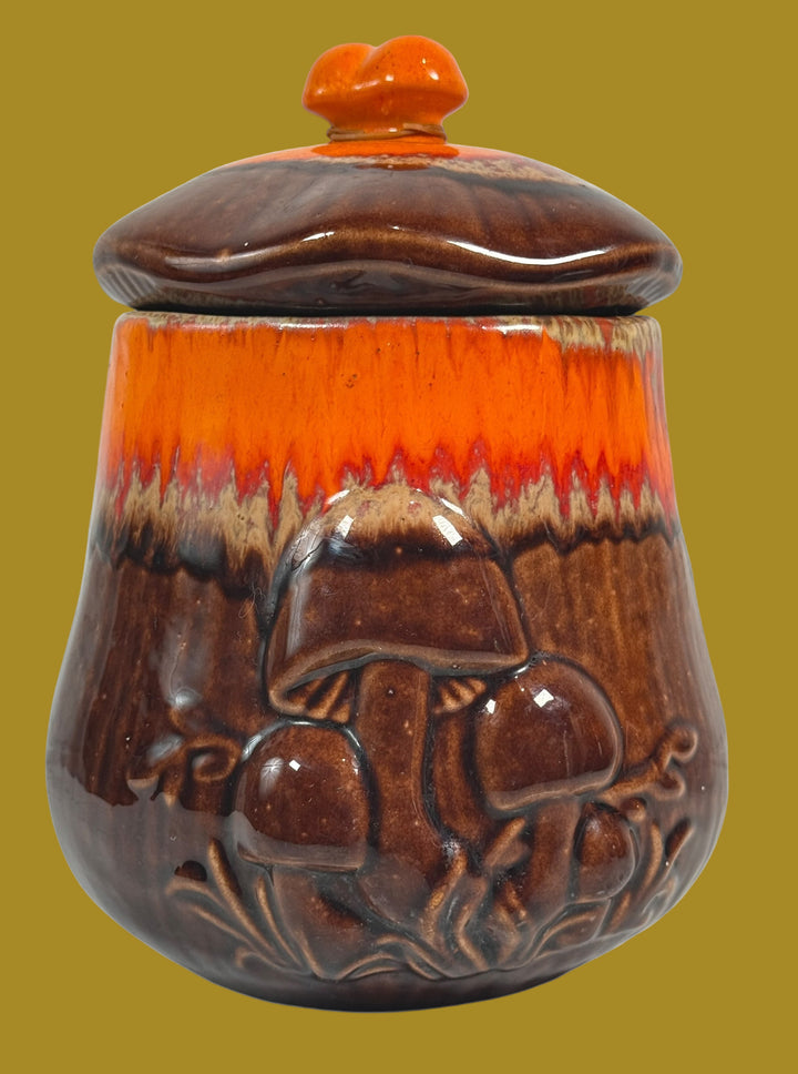 Ceramic jar with lid featuring a mushroom design on a white background