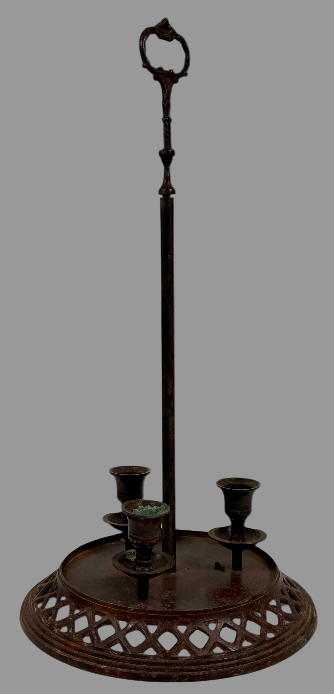 Decorative metal stand with candle holders on a white background