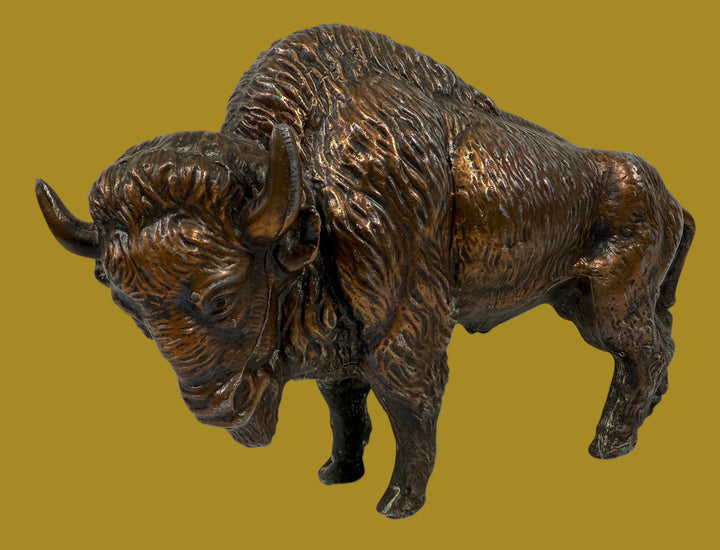 Bronze statue of a bison on a white background