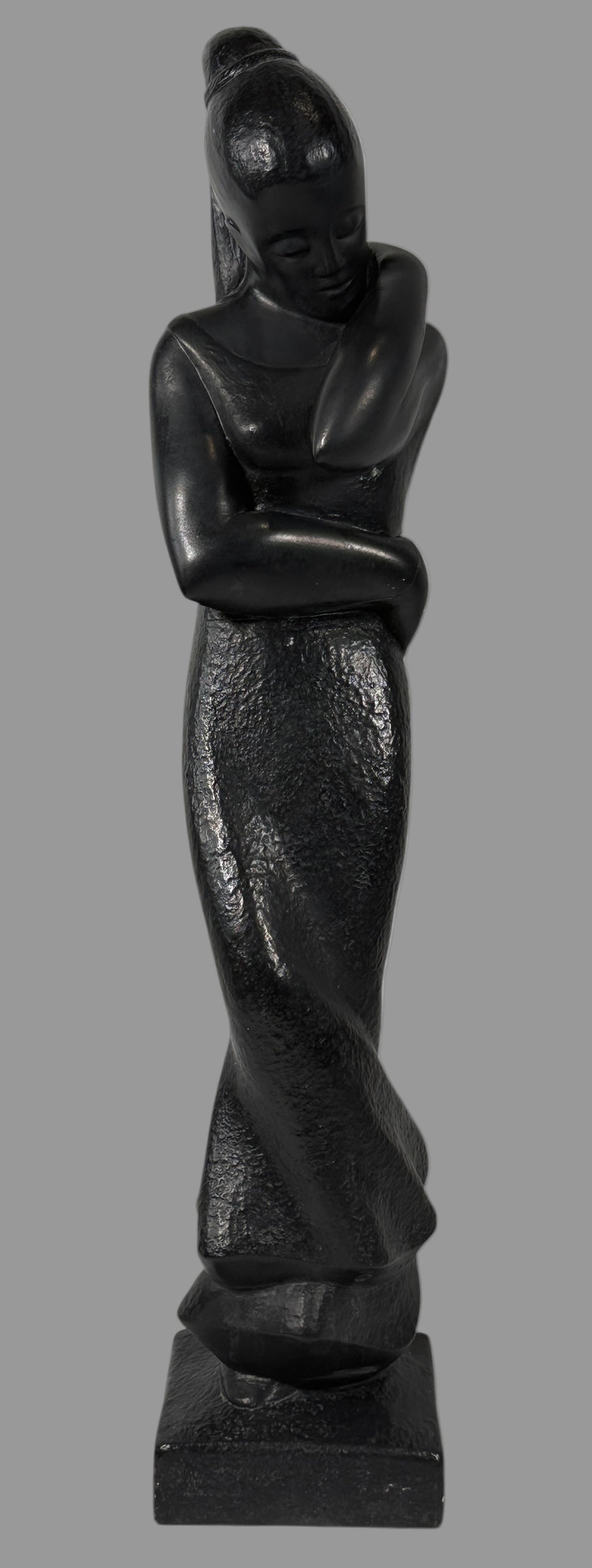 Austin Productions  1908, Black stone sculpture of a standing figure on a white background