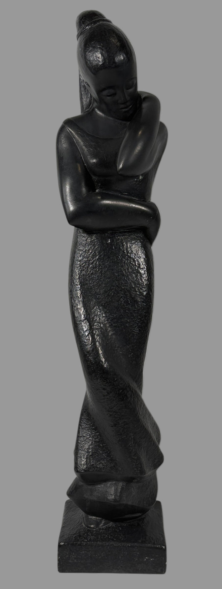 Austin Productions  1908, Black stone sculpture of a standing figure on a white background
