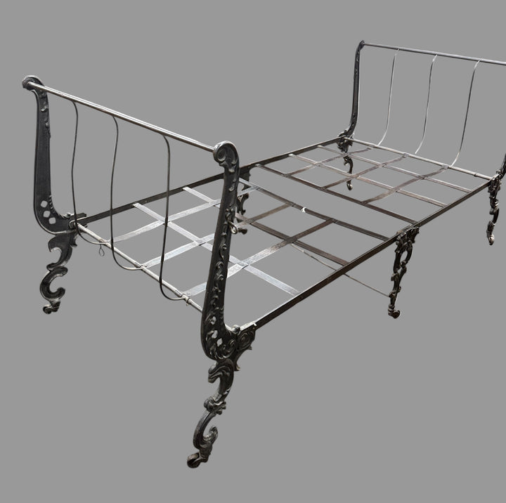 Wrought iron bed frame on a white background. Circa 1900, 