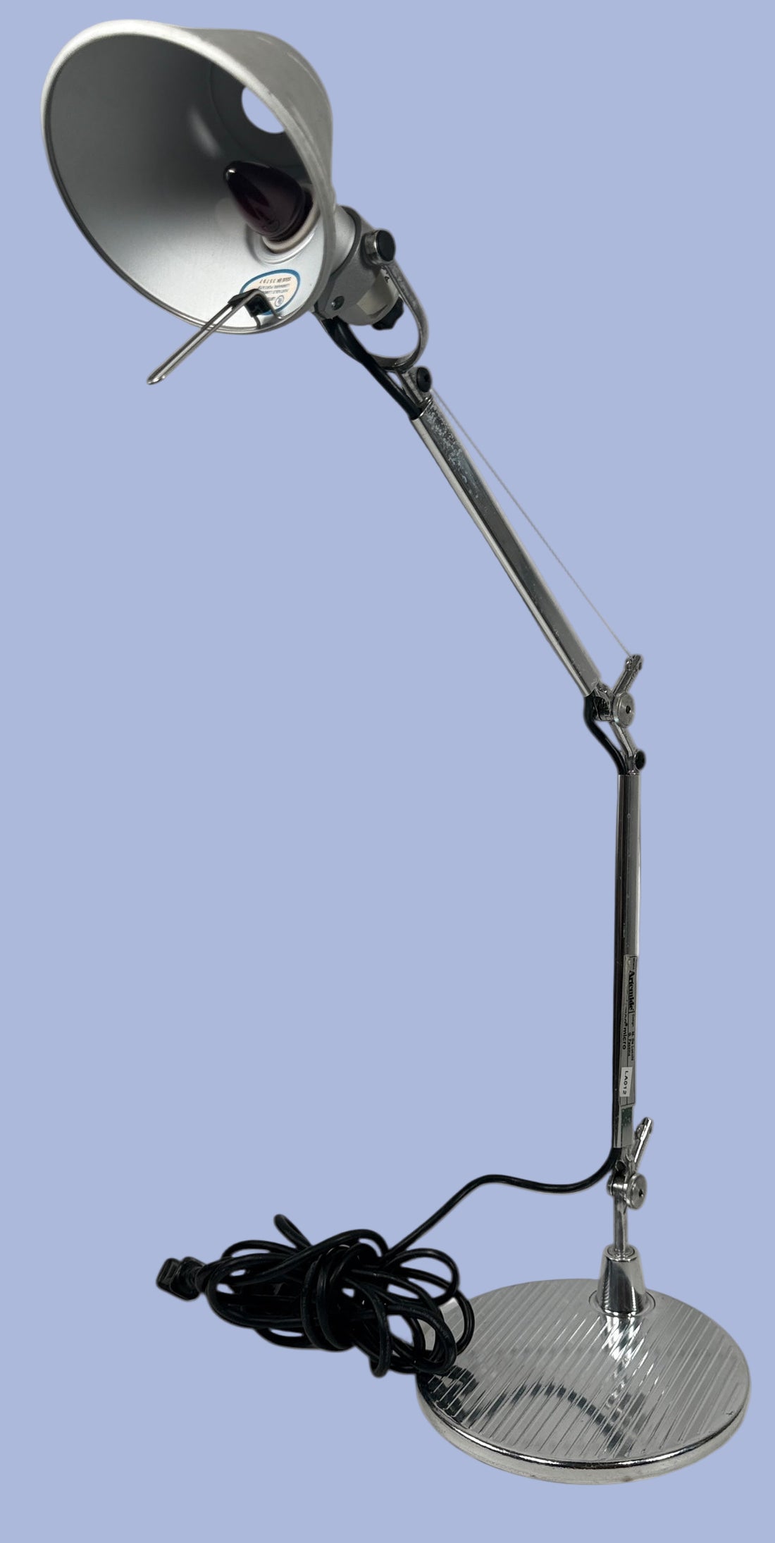 Artemide. Italy ,Metal desk lamp with adjustable arm on a white background