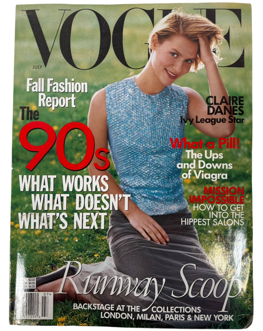 Vogue July 1998  magazine cover featuring a woman in a blue dress with text about fashion and lifestyle topics.  