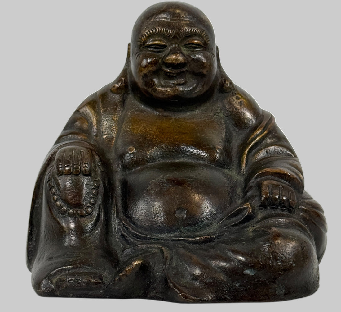 Bronze Buddha statue on a white background