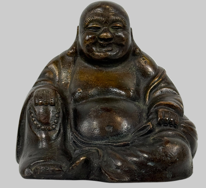 Bronze Buddha statue on a white background