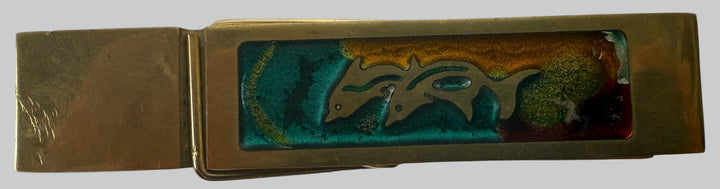 Metallic money clip with a logo on a white background