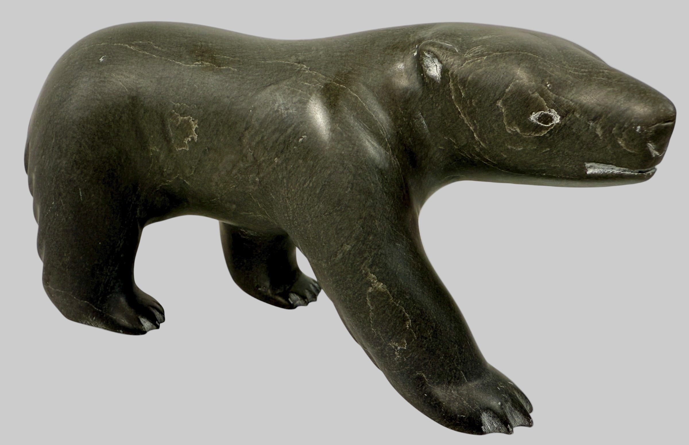 Signed Inuit soapstone bear by Joe Ittukalak (2004) from Nunavik. 10-inch Canadian carving in dark stone—authentic Indigenous art sculpture.