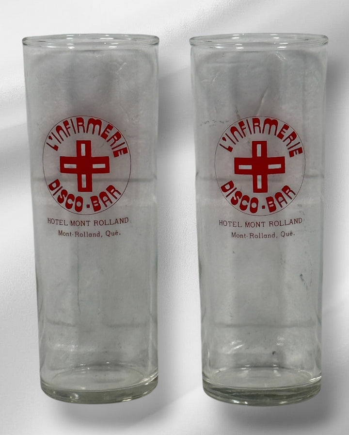 Vintage L’Infirmerie Disco-Bar souvenir glasses from Mont-Rolland, Québec. Rare nightlife memorabilia in excellent condition. Pair of original high-ball glasses.