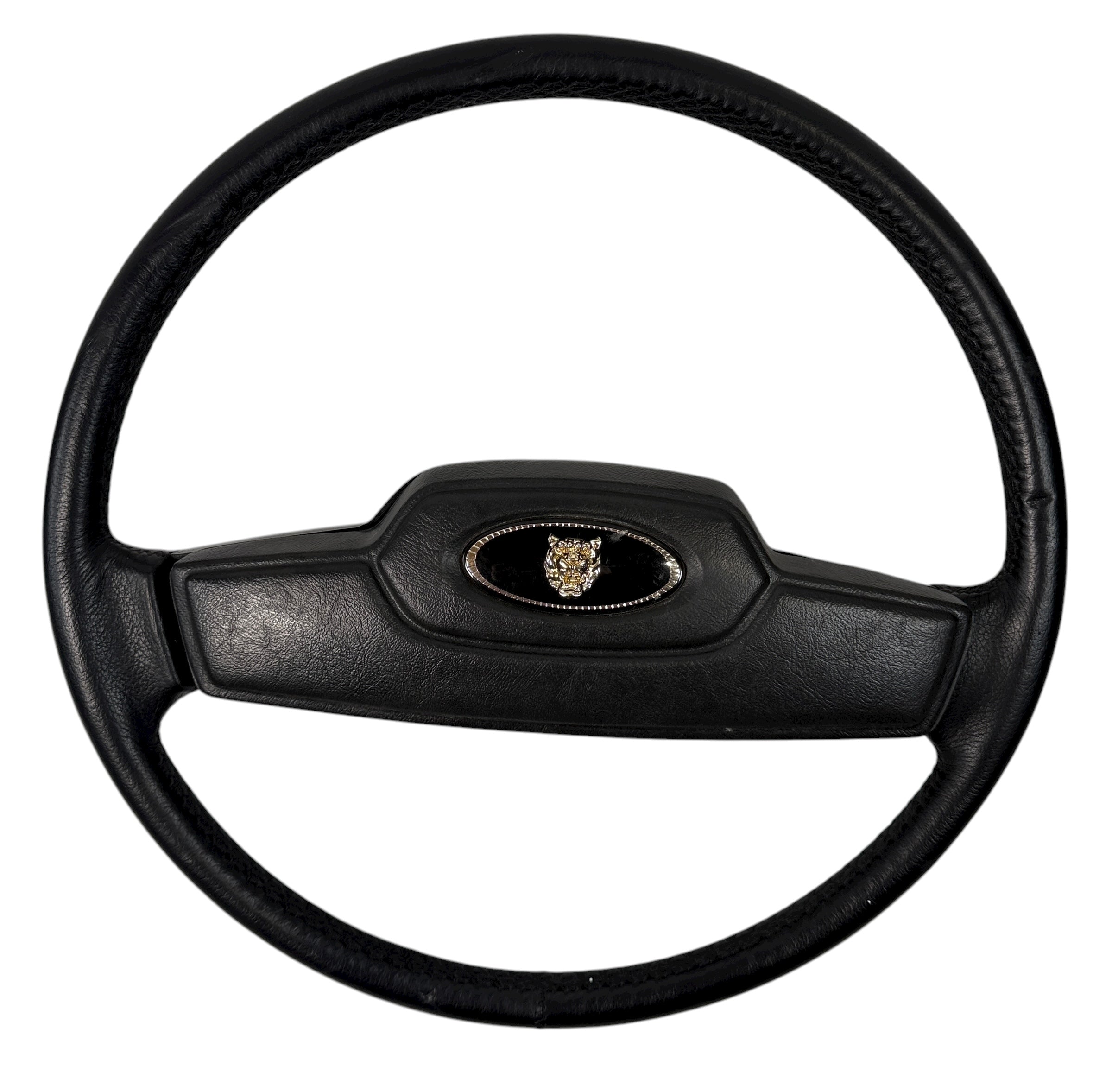 OEM Jaguar XJ6 Series III steering wheel with horn pad. Genuine 1980–87 UK-made replacement part in good driver condition. Vintage Jaguar interior collectible.