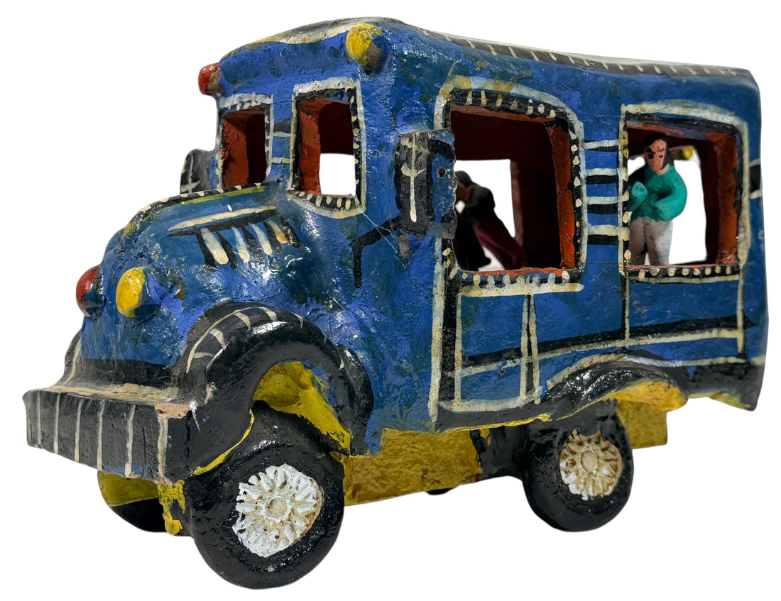 Vintage Mexican papier-mâché colectivo bus sculpture with hand-modeled interior figures. Folk art narrative piece with bold color and strong display presence.