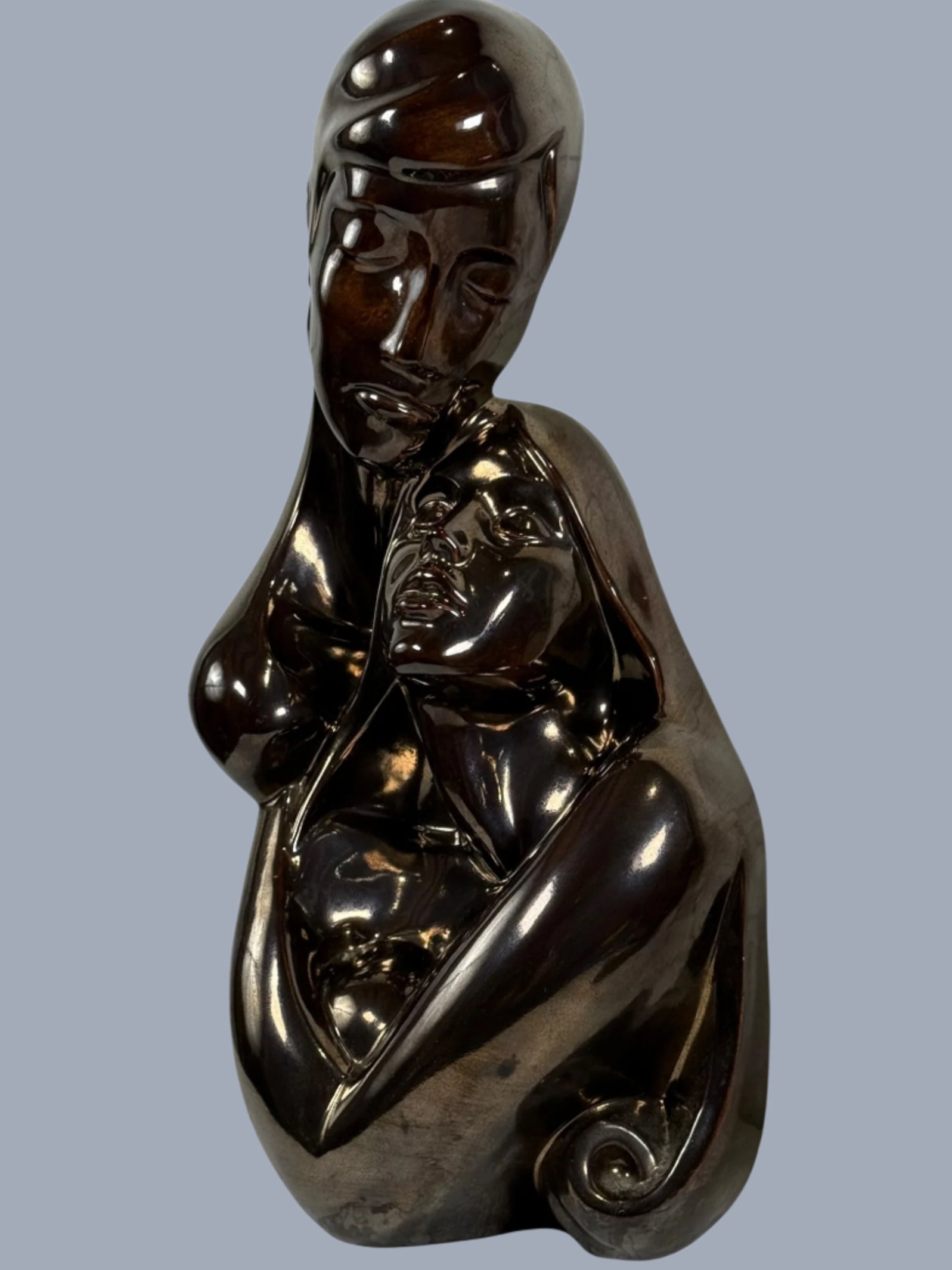 Bronze sculpture of a nude figure on a white background