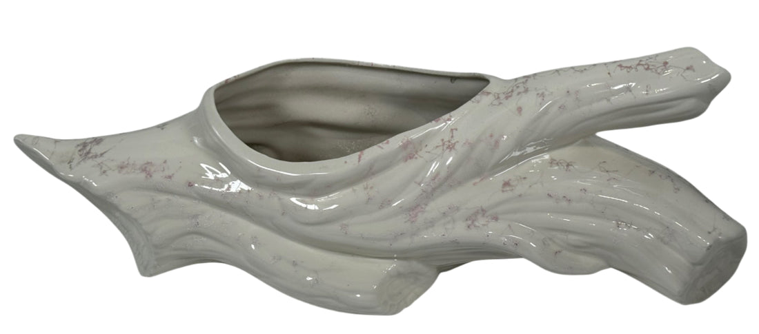 Ceramic planter shaped like a leaf on a white background