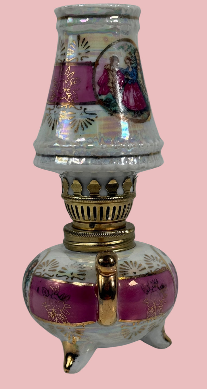 Decorative oil lamp with intricate designs on a white background