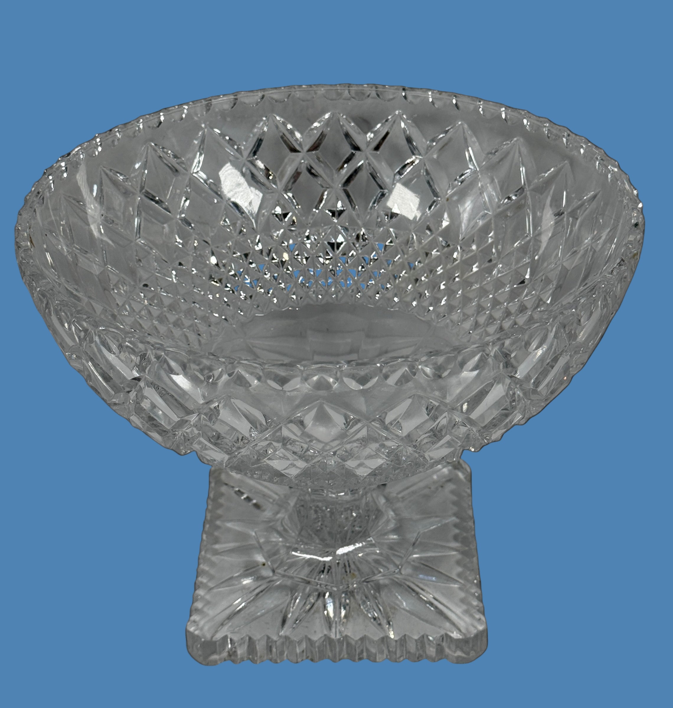Clear crystal footed bowl on a black background