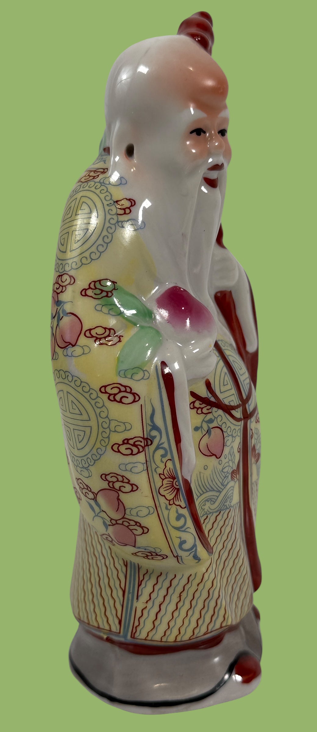 Decorative ceramic figure with intricate patterns on a white background