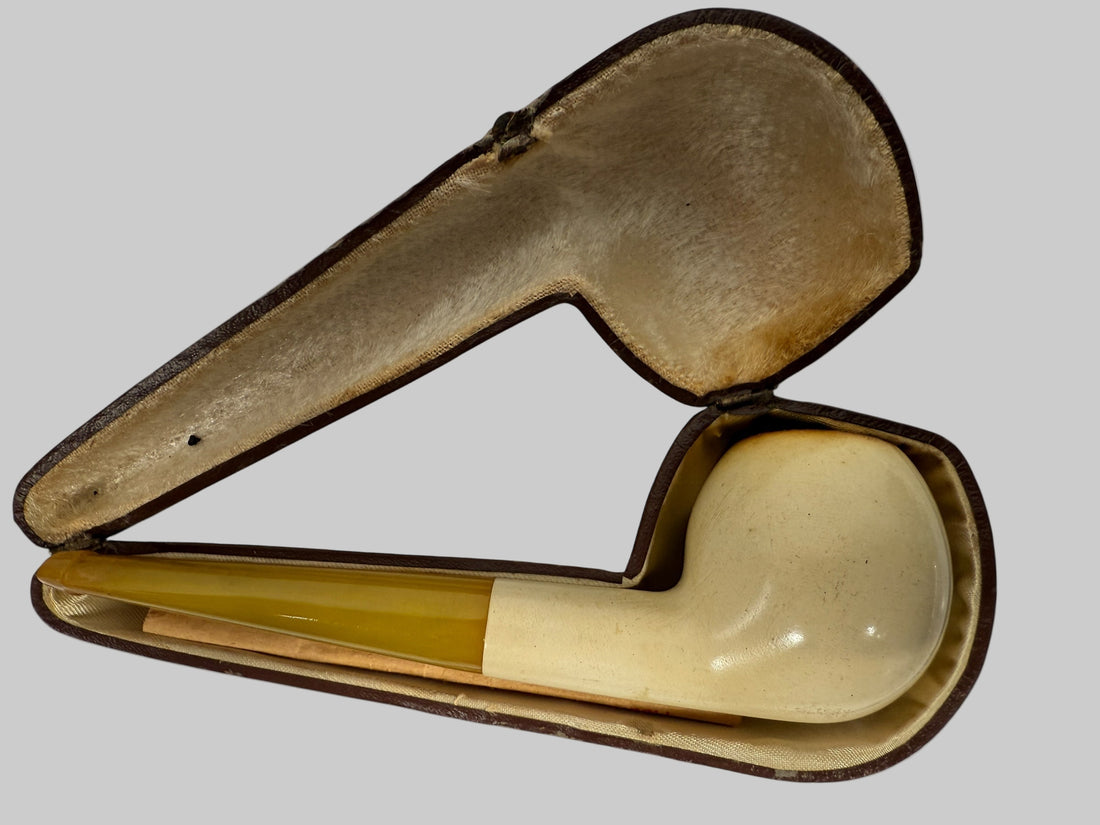 Vintage tobacco pipe in an open case on a white background