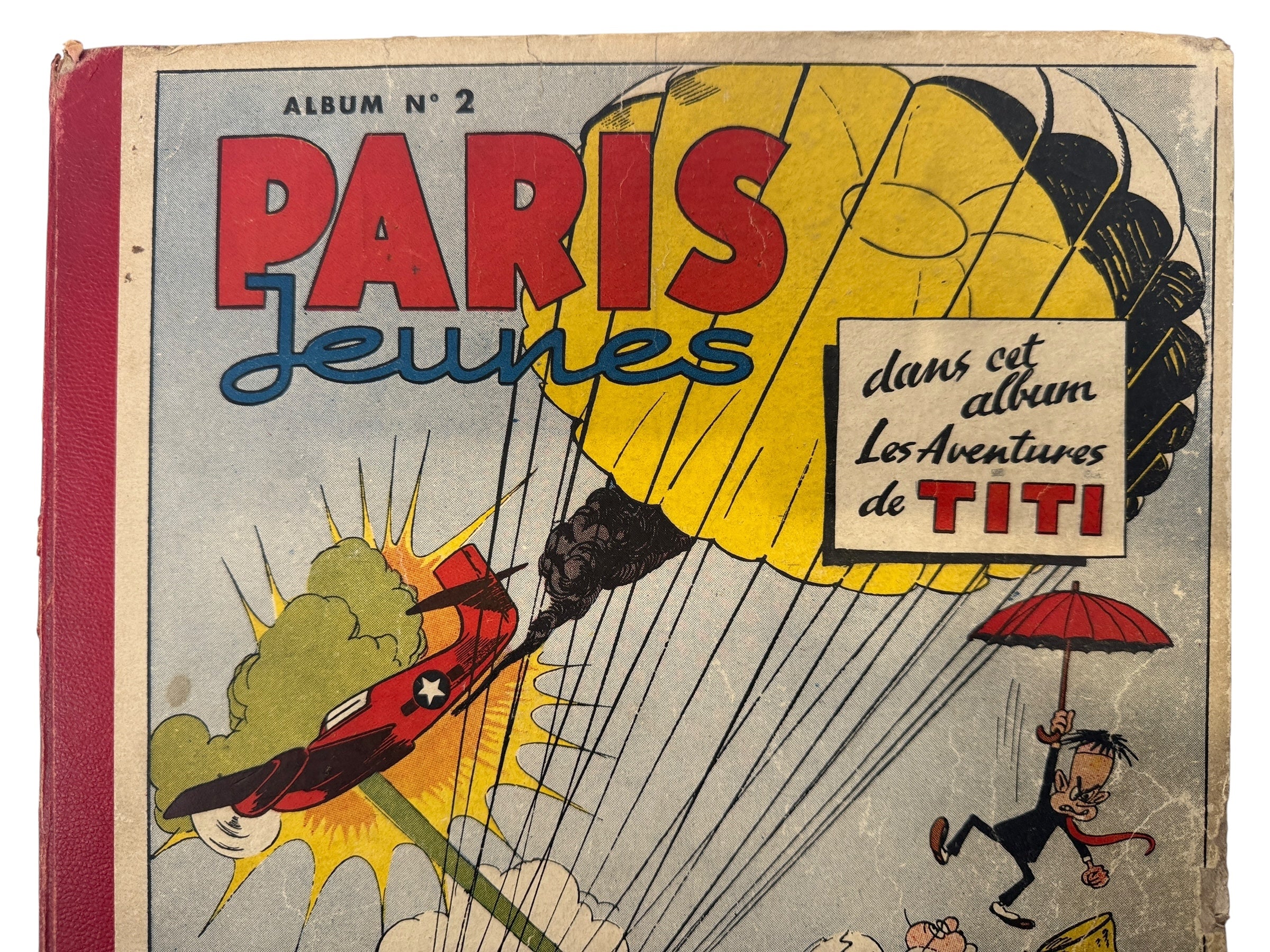 Vintage book cover with cartoon characters and text about 'Les Aventures de Titi' in Paris.