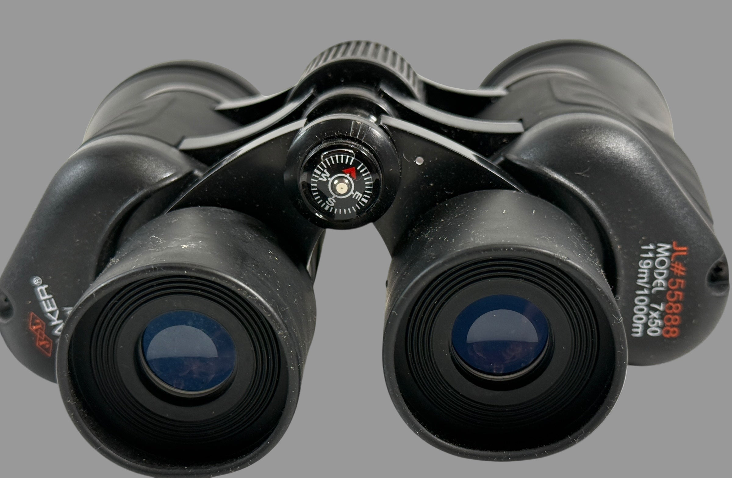 Black binoculars with focus wheel on a white background