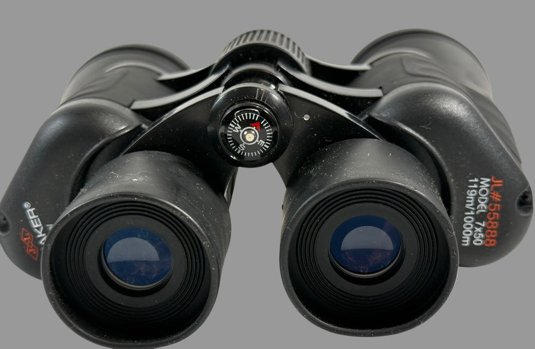 Black binoculars with focus wheel on a white background
