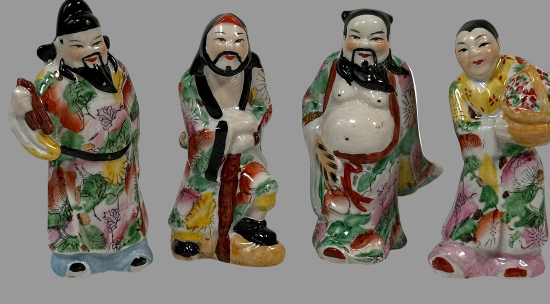 Four colorful ceramic figurines on a white background