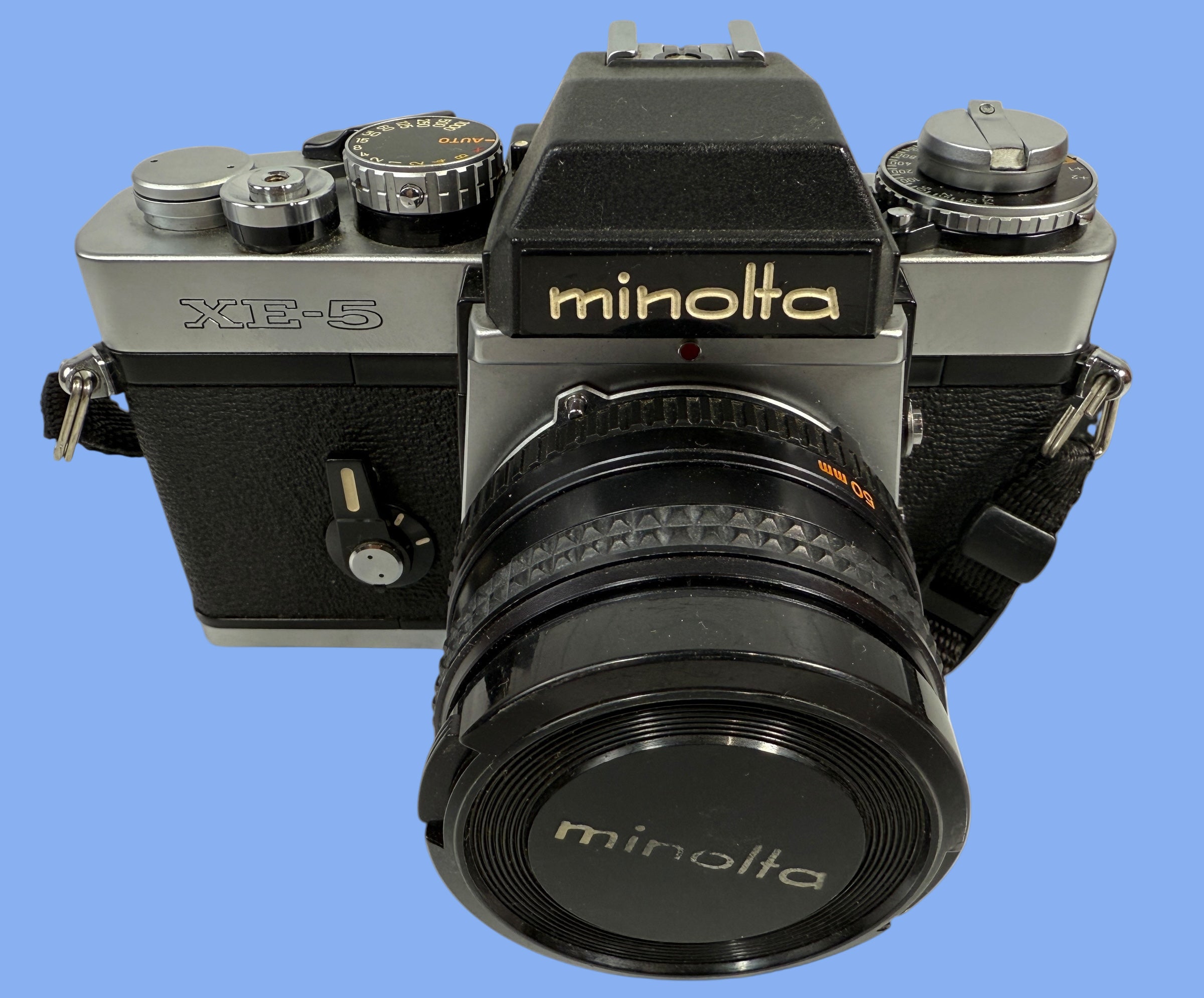 Minolta camera with lens on a white background