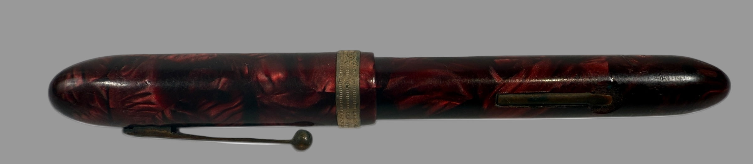 Black and red pen with decorative design on a white background, Penco