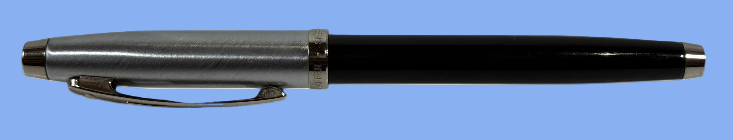 Schaeffer, Black pen with silver accents on a white background