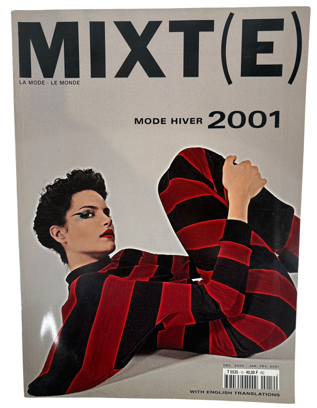 Magazine cover titled 'MIXT(E)' with a person wearing a red and black patterned outfit, featuring the text 'Mode Hiver 2001'.