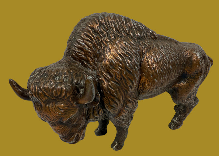 Bronze statue of a bison on a white background