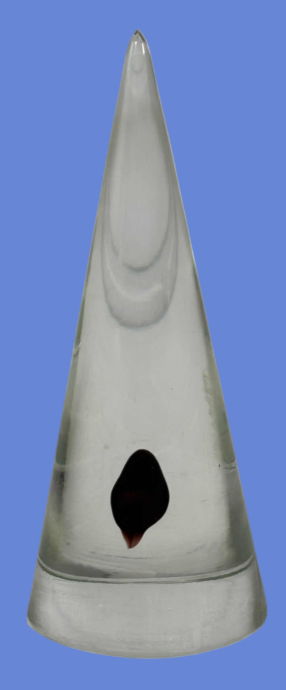 Vintage clear glass cone paperweight with dark red-brown inclusion. Mid-century modern décor collectible, polished base, unsigned art glass accent.