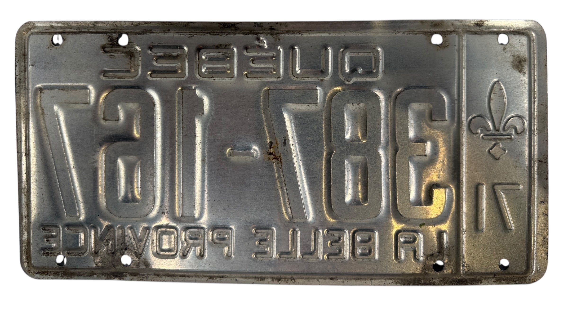 Vintage metal license plate with embossed text and design