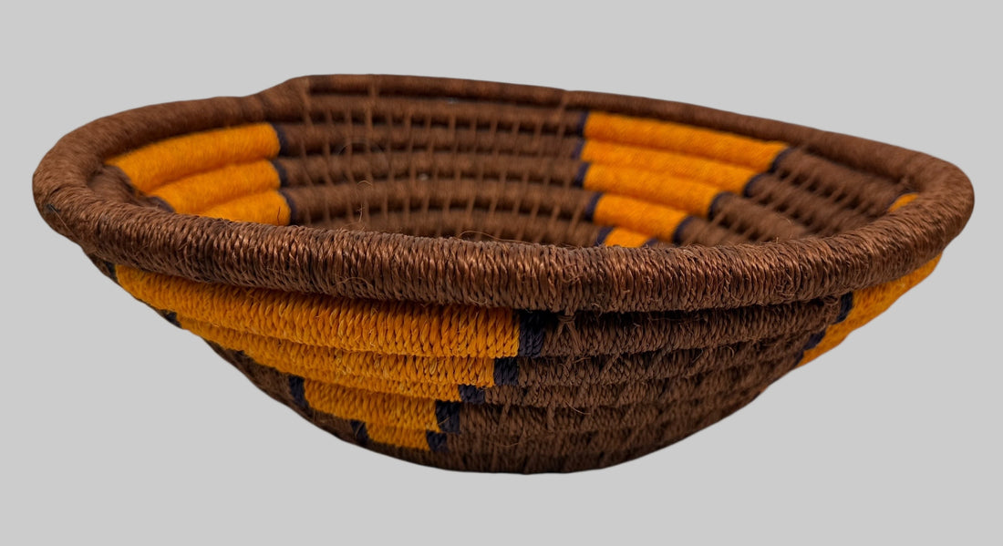 Woven basket with brown and orange pattern on a white background