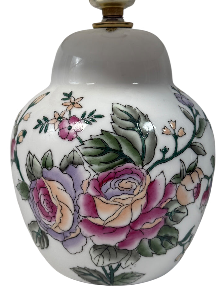 Decorative ceramic table lamp  with floral designs on a white background