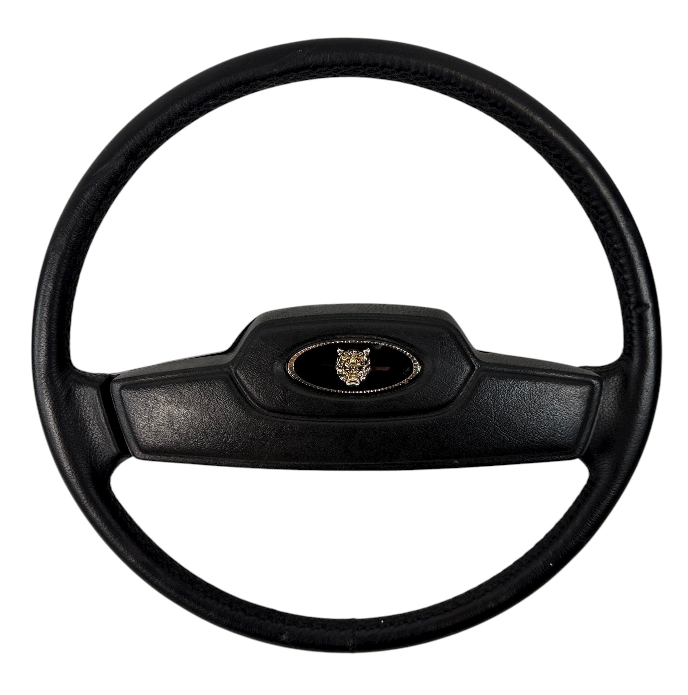 OEM Jaguar XJ6 Series III steering wheel with horn pad. Genuine 1980–87 UK-made replacement part in good driver condition. Vintage Jaguar interior collectible.