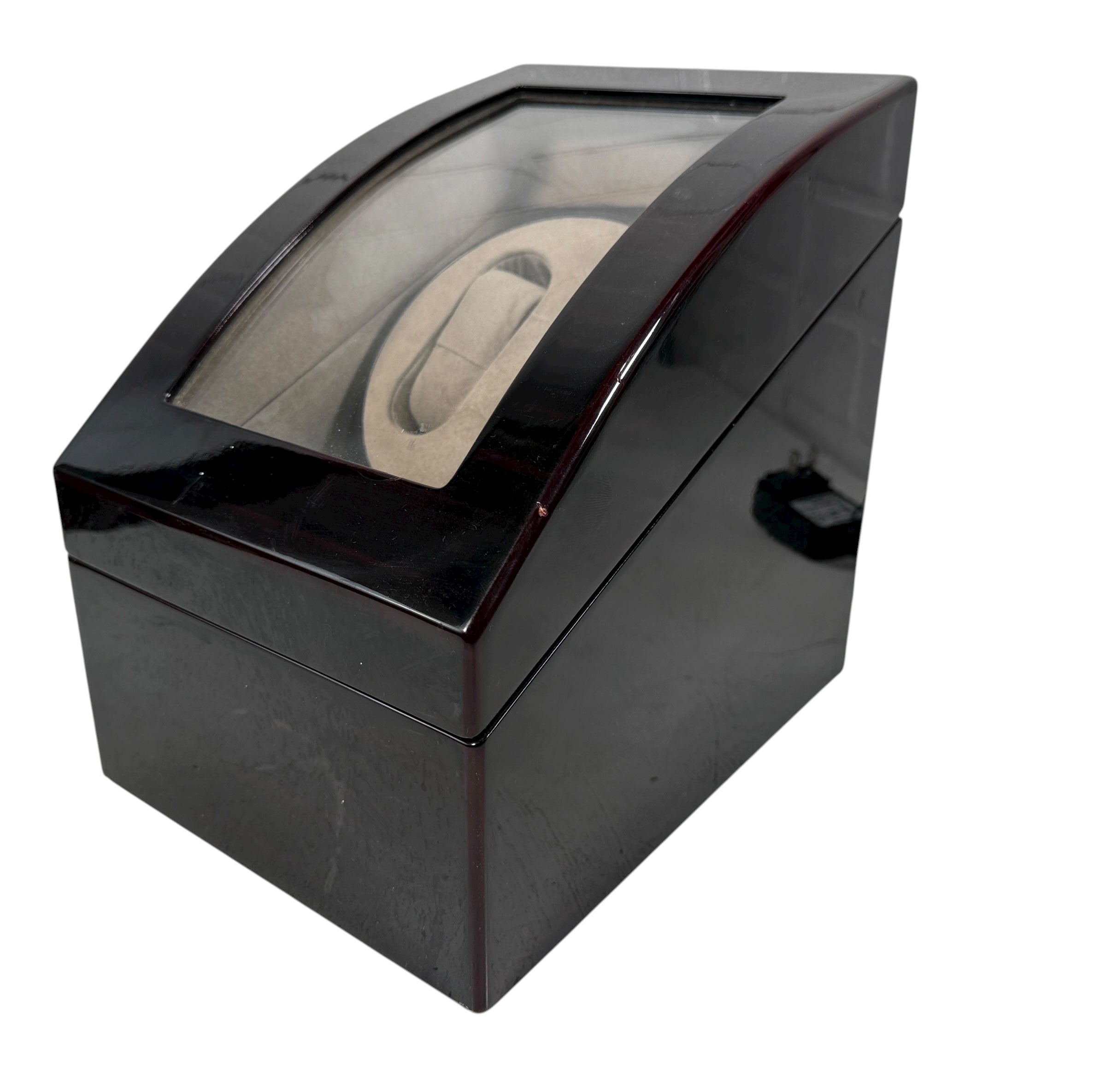 Working dual automatic watch winder in piano black lacquer with storage, display lid, and AC adaptor. Clean, functional, and perfect for protecting your watches.