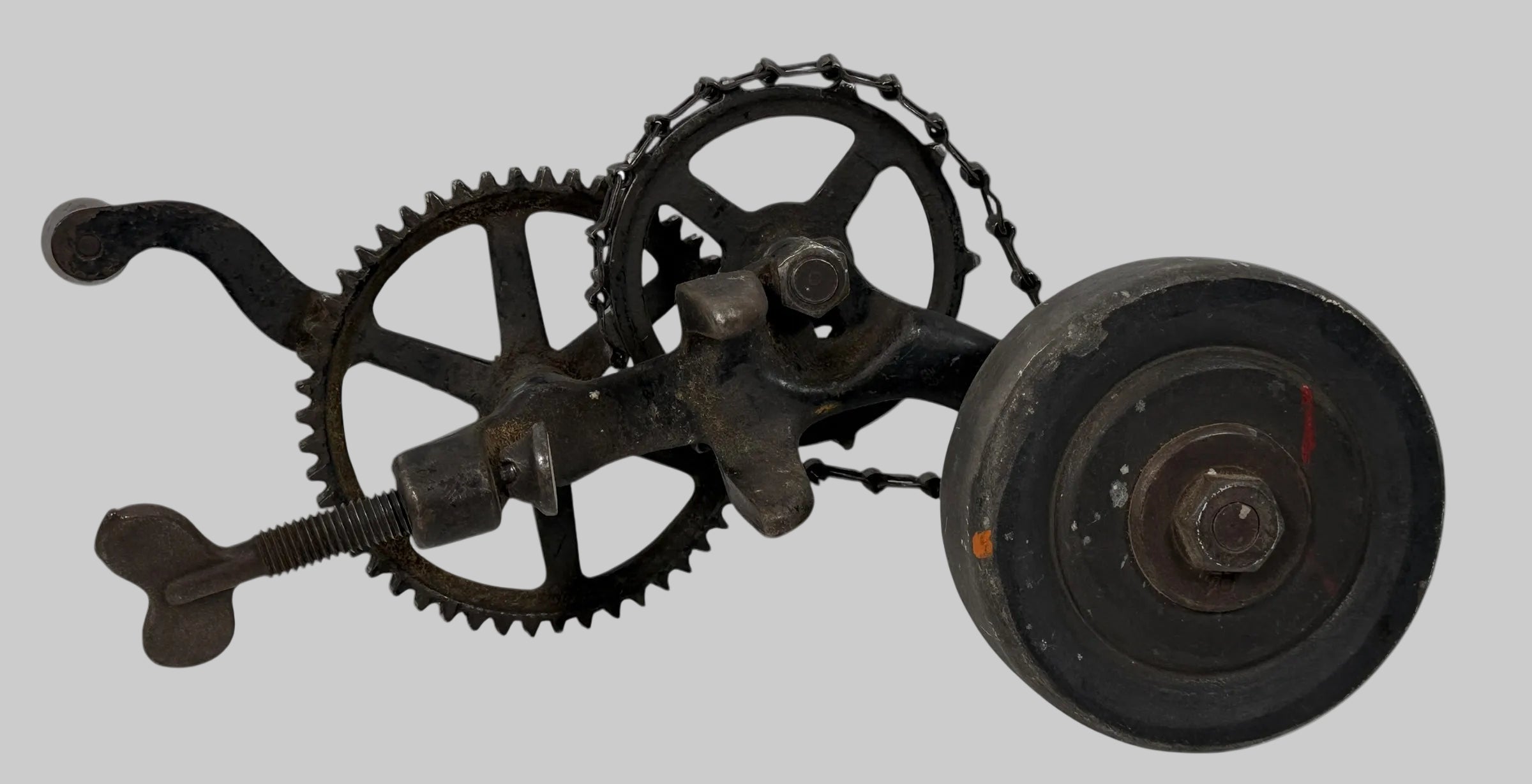 Working antique clamp-on cast-iron grinder with chain drive. Compact 19th-century sharpening tool, fully functional. Industrial décor or collector piece.
