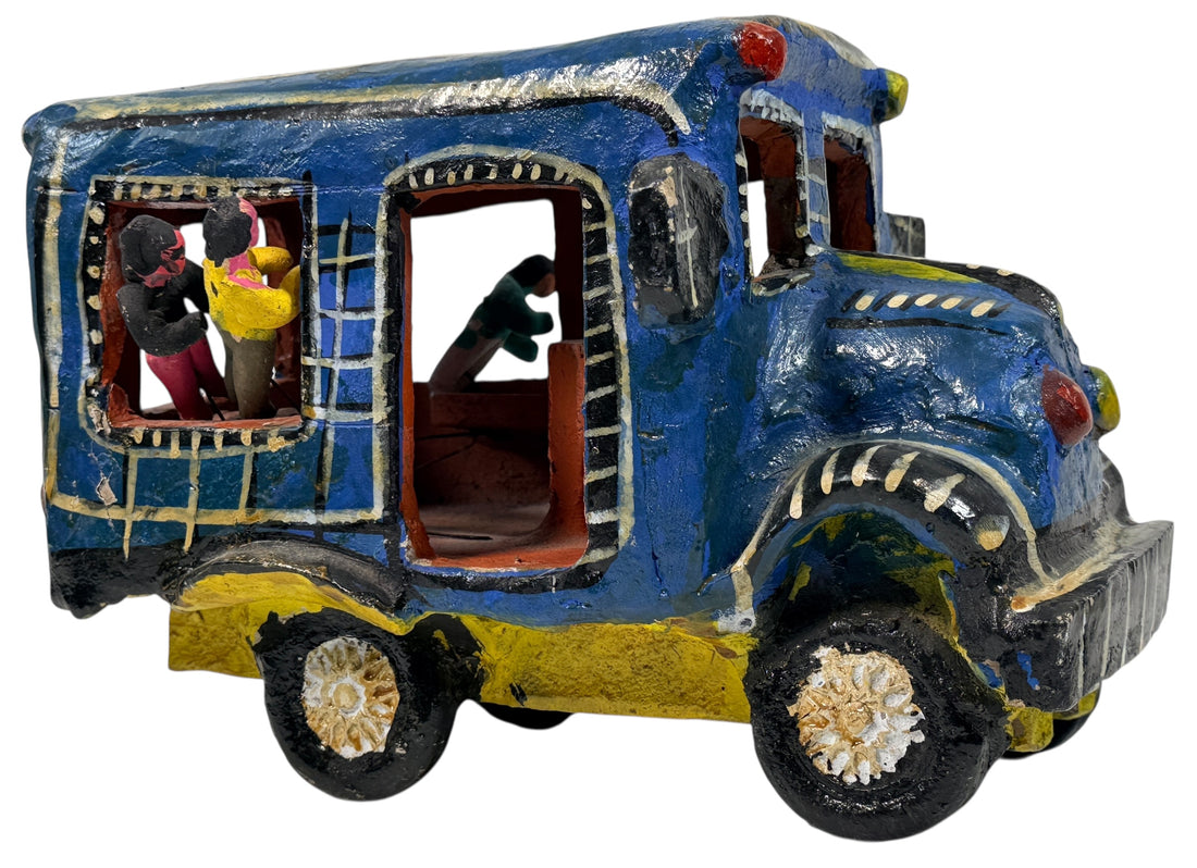 Vintage Mexican papier-mâché colectivo bus sculpture with hand-modeled interior figures. Folk art narrative piece with bold color and strong display presence.